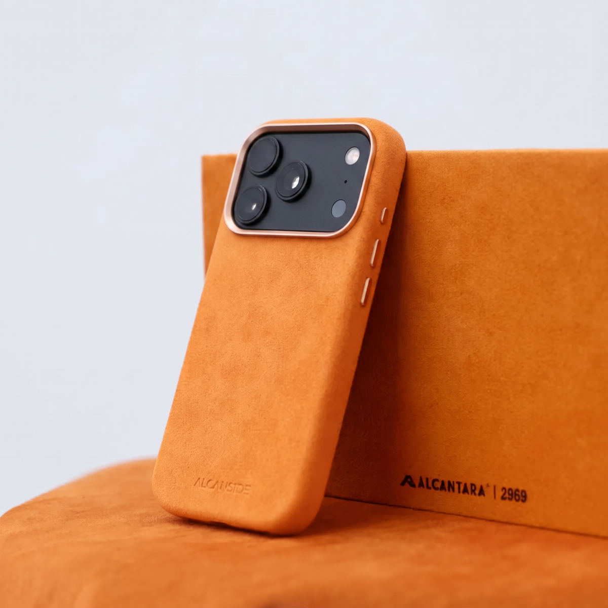 Orange Alcantara case for iPhone 18 Pro held in hands #iPhone model:_iPhone 18 Pro|iPhone 18 Pro Max